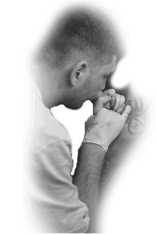 Tattoo artist Dan in profile wearing white gloves, tattooing a portrait on a client's arm, black-and-white photo, Vienna