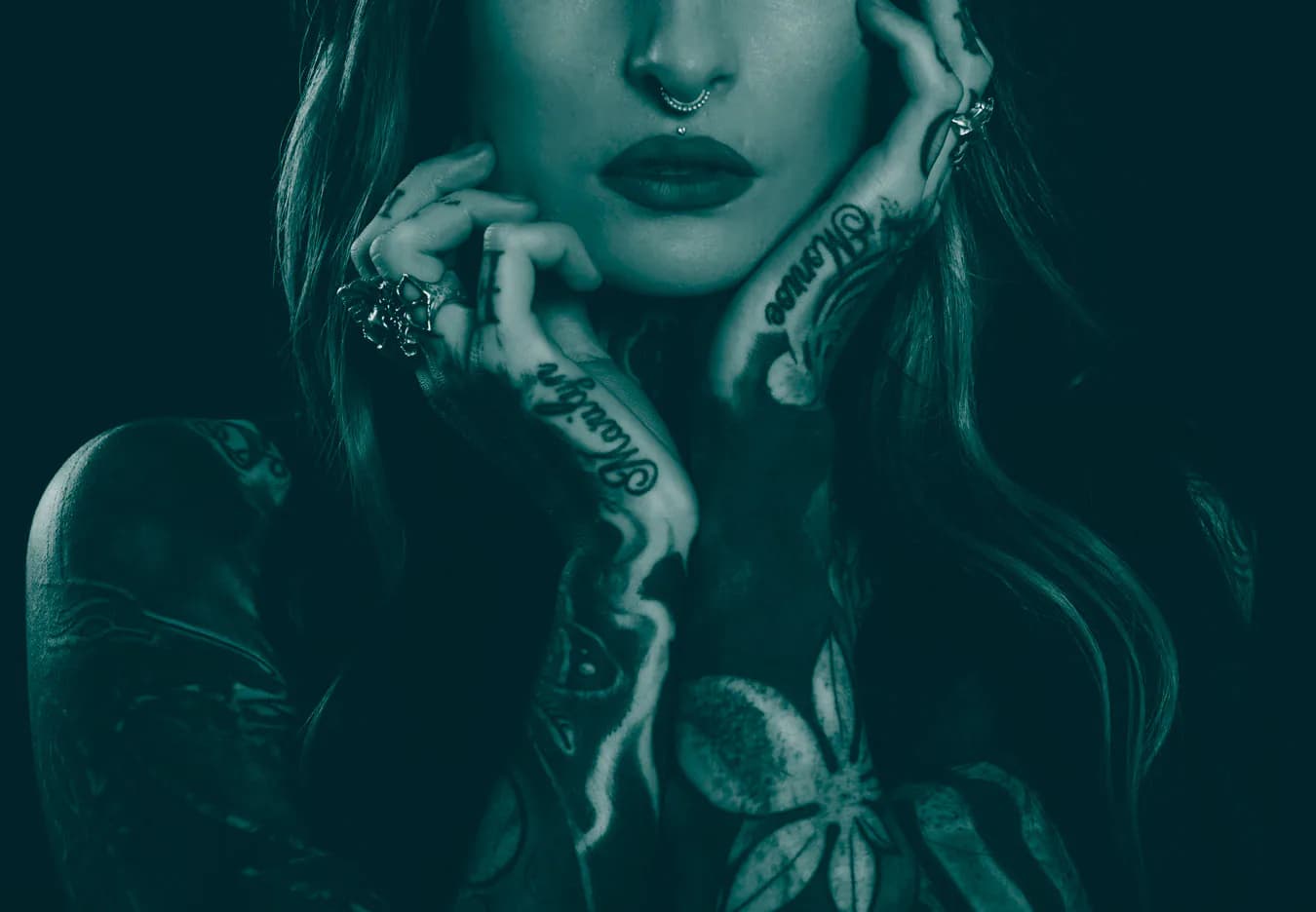 Woman with tattooed hands, finger lettering and floral arm tattoos - cover image of Ink21 Tattoo Studio Vienna