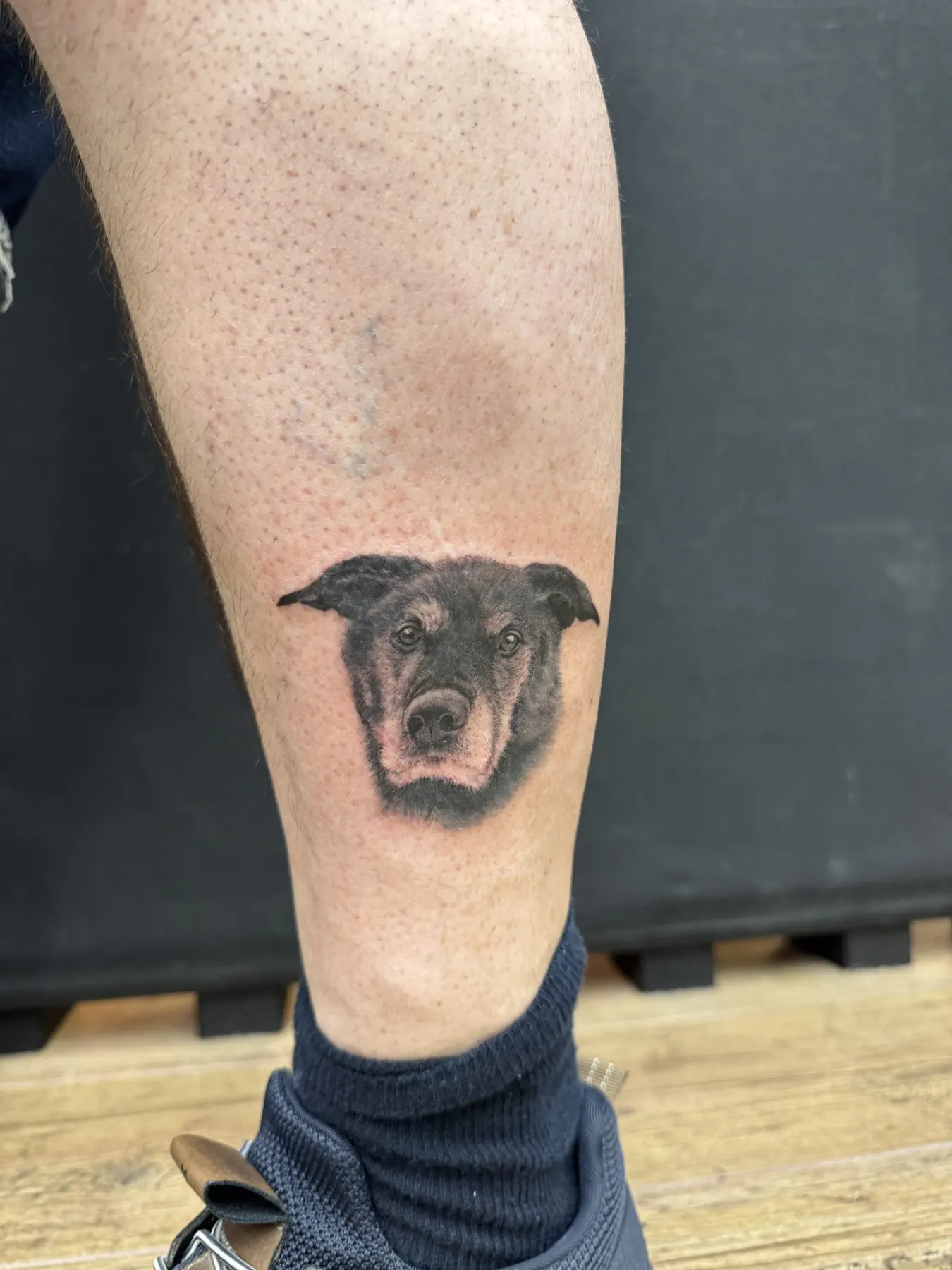 Small dog’s head on the lower leg. Tattoo at Ink21 in Vienna.