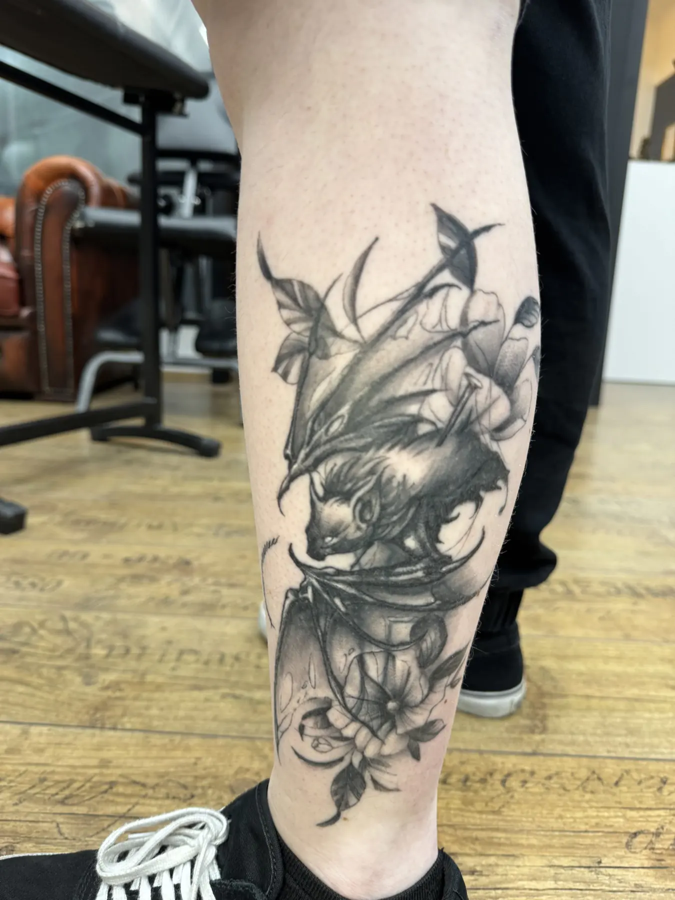 Skull with flowers and leaves. Tattoo at Ink21 in Vienna.