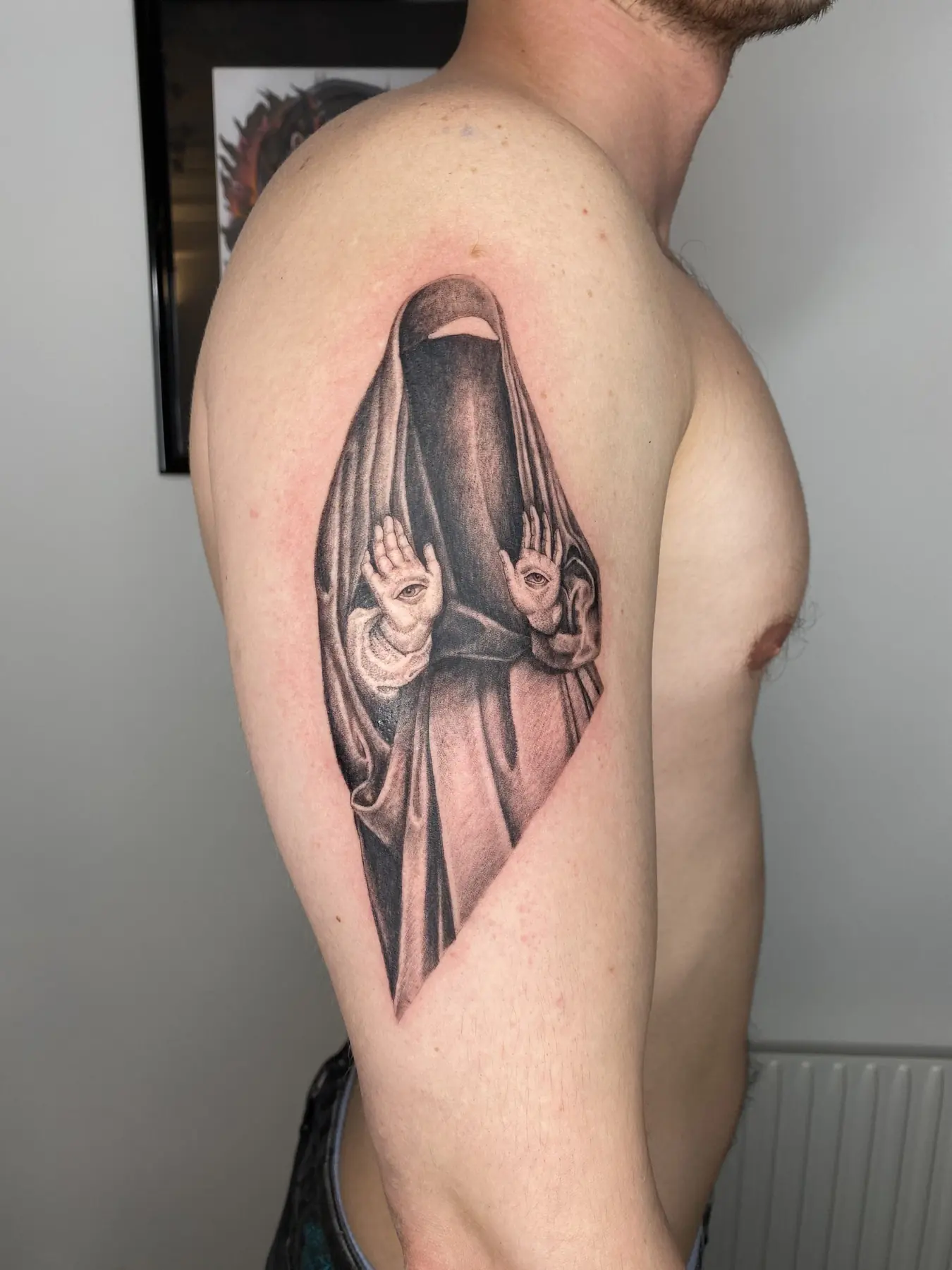 Veiled figure with eyes in its palms. Tattoo at Ink21 in Vienna.