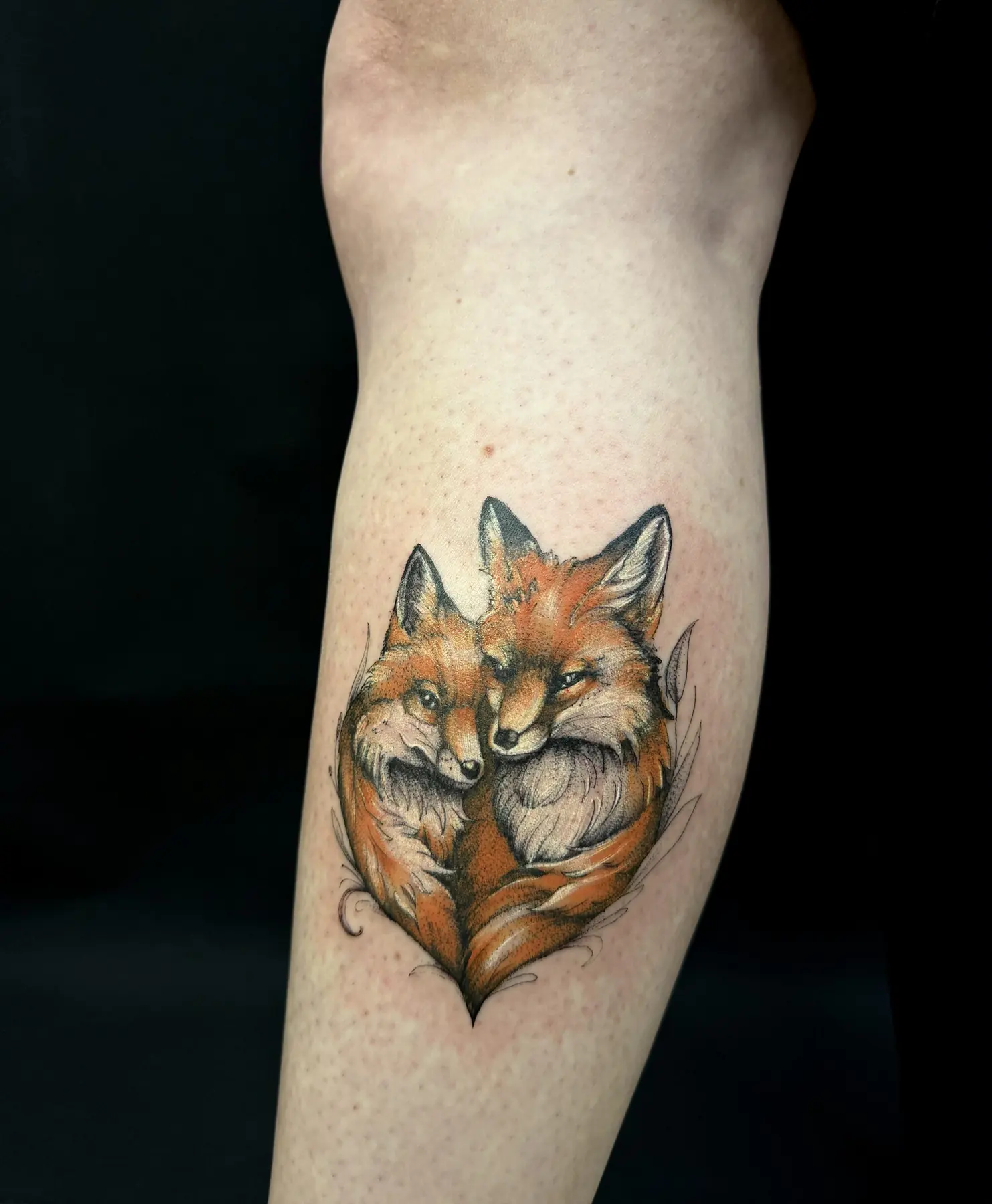 Two foxes in a heart shape. Tattoo at Ink21 in Vienna.