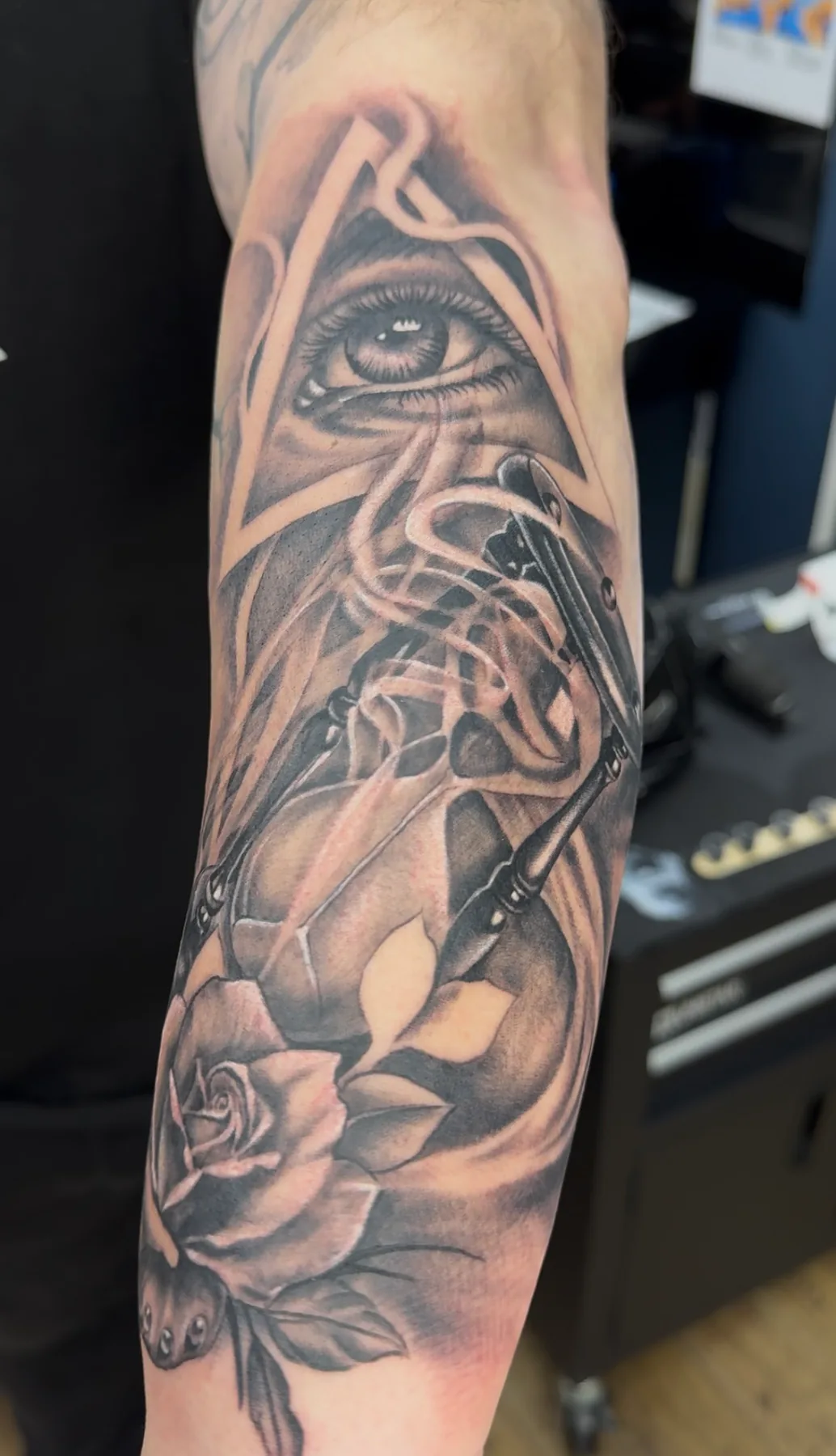 Eye in a triangle above a rose. Tattoo at Ink21 in Vienna.