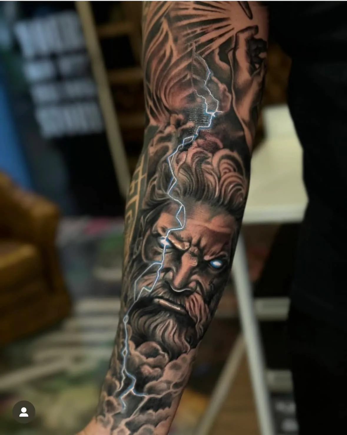 Bearded face among lightning bolts. Tattoo at Ink21 in Vienna.