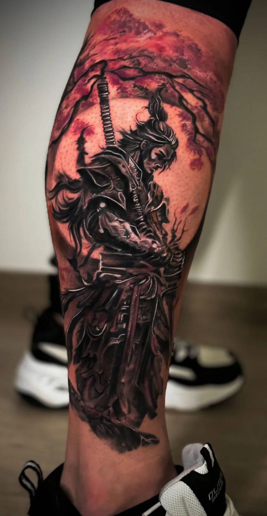 Armed warrior against a red background. Tattoo at Ink21 in Vienna.