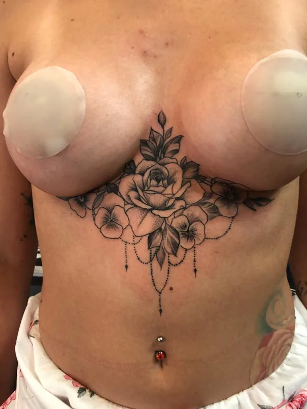 Floral ornament beneath the chest. Tattoo at Ink21 in Vienna.