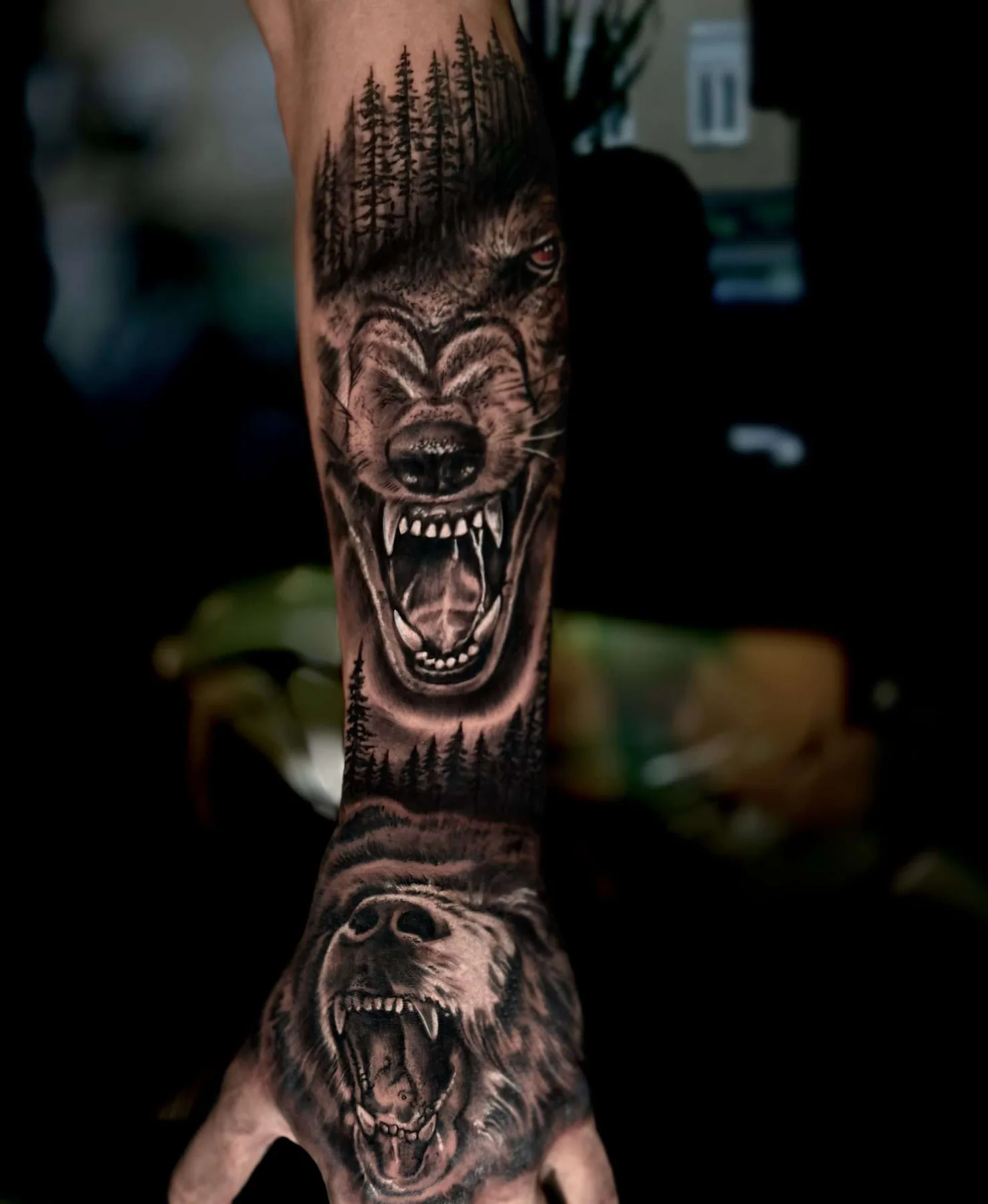 Roaring animals with a forest silhouette. Tattoo at Ink21 in Vienna.