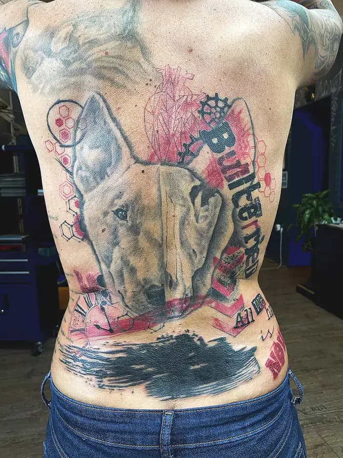 Bull terrier against red graphic shapes. Tattoo at Ink21 in Vienna.