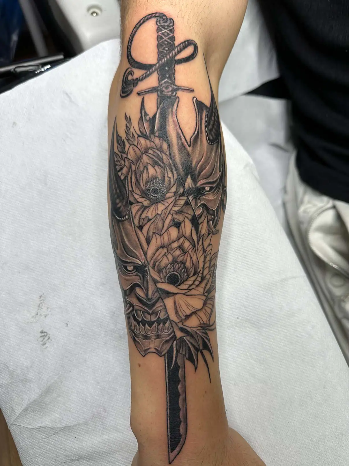 Dragon head above a long blade. Tattoo at Ink21 in Vienna.