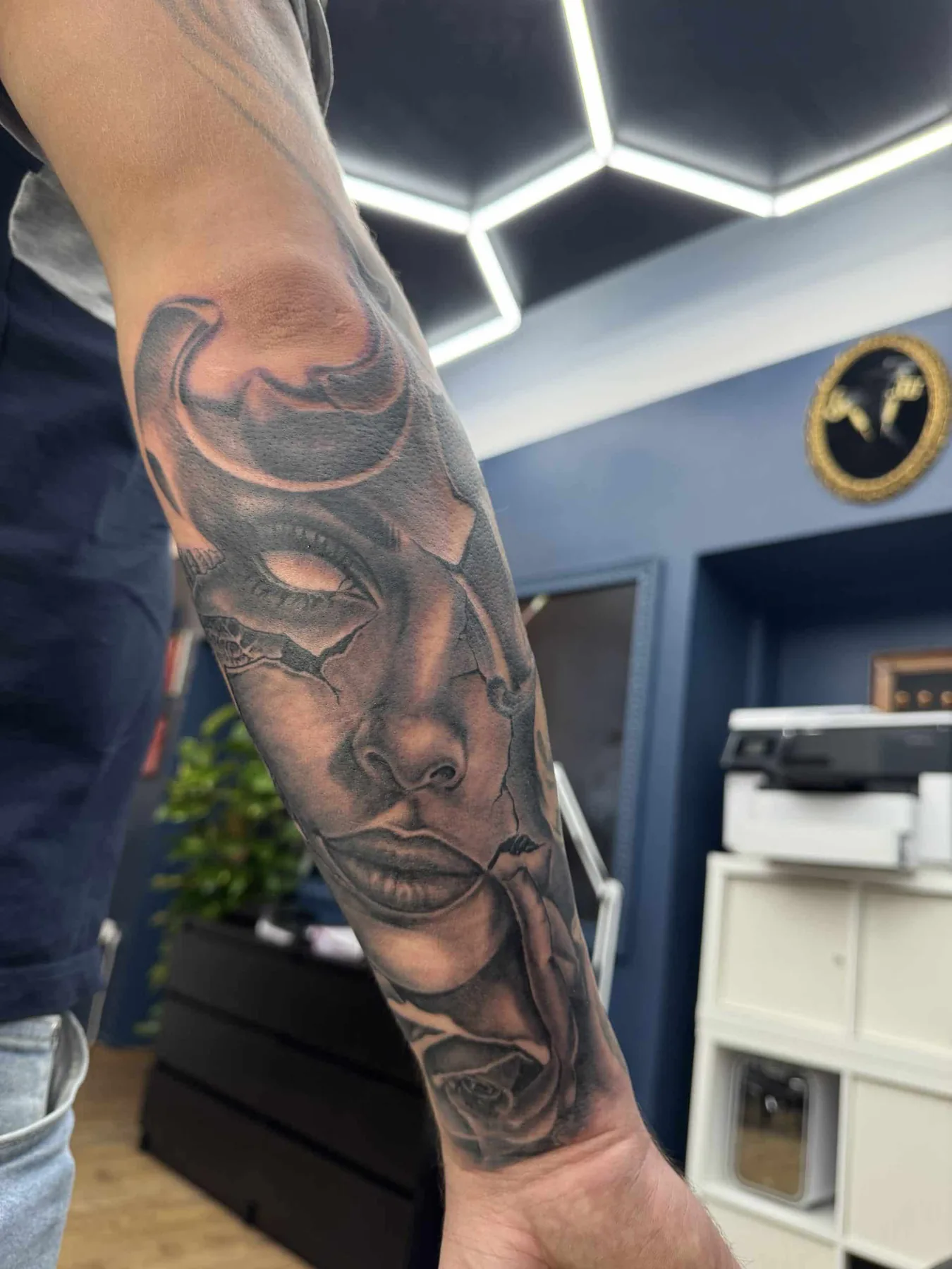 Dark masked face on the inner arm. Tattoo at Ink21 in Vienna.