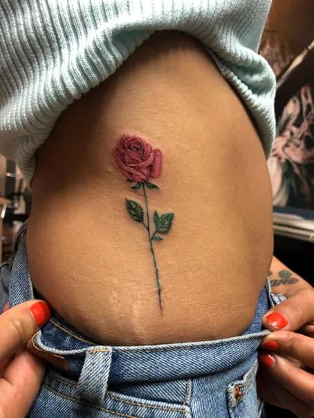 Single red rose on the hip. Tattoo at Ink21 in Vienna.