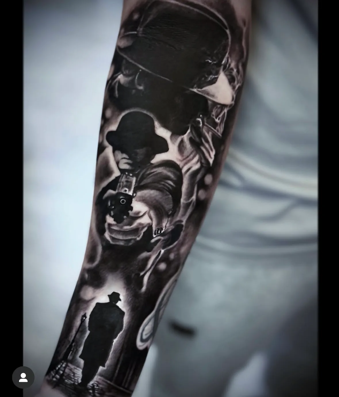 Bowler-hatted figure in a dark sleeve. Tattoo at Ink21 in Vienna.