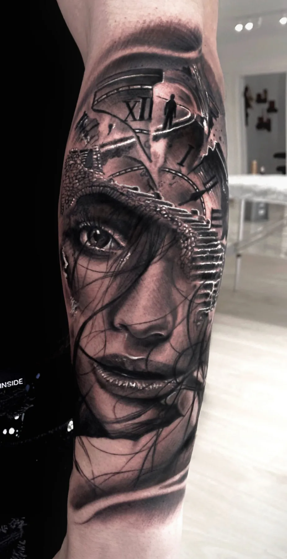 Woman’s face beneath a broken clock. Tattoo at Ink21 in Vienna.