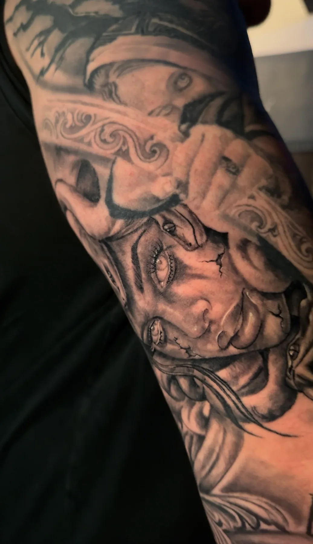 Woman’s face beneath an ornate helmet. Tattoo at Ink21 in Vienna.