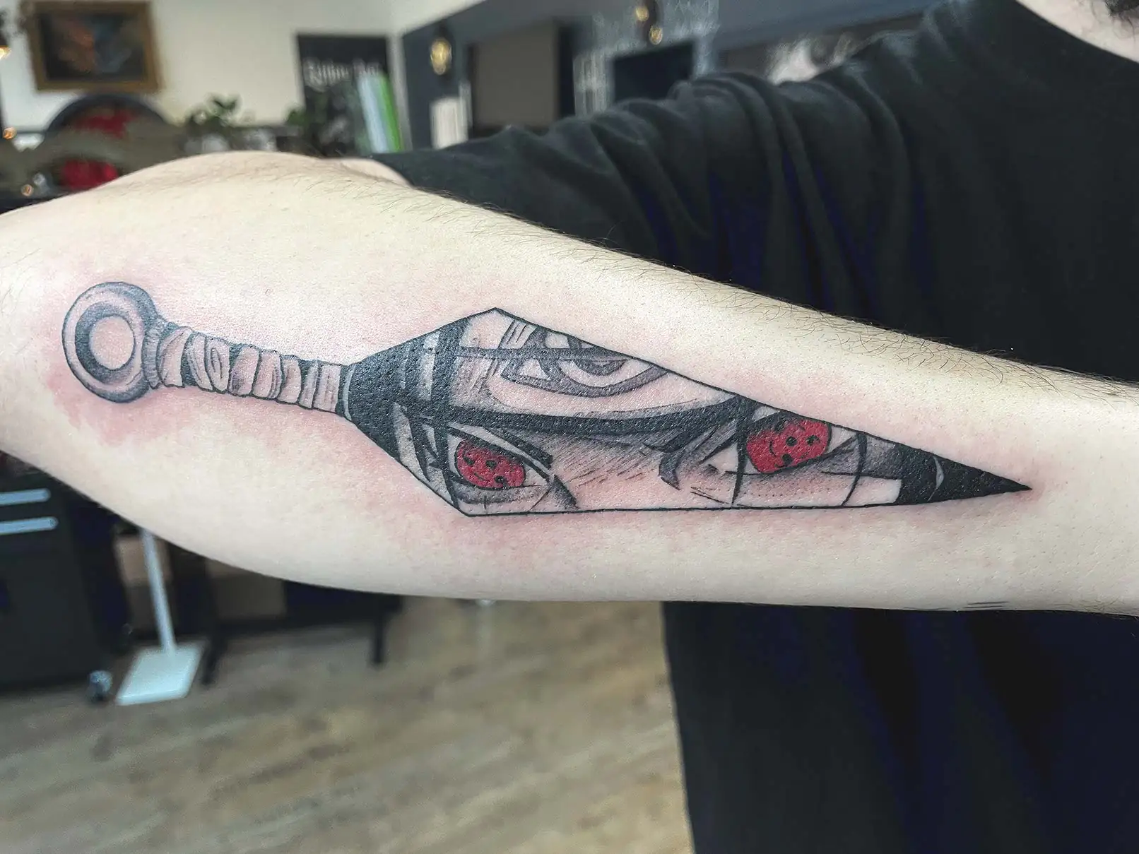 Kunai with red anime eyes. Tattoo at Ink21 in Vienna.