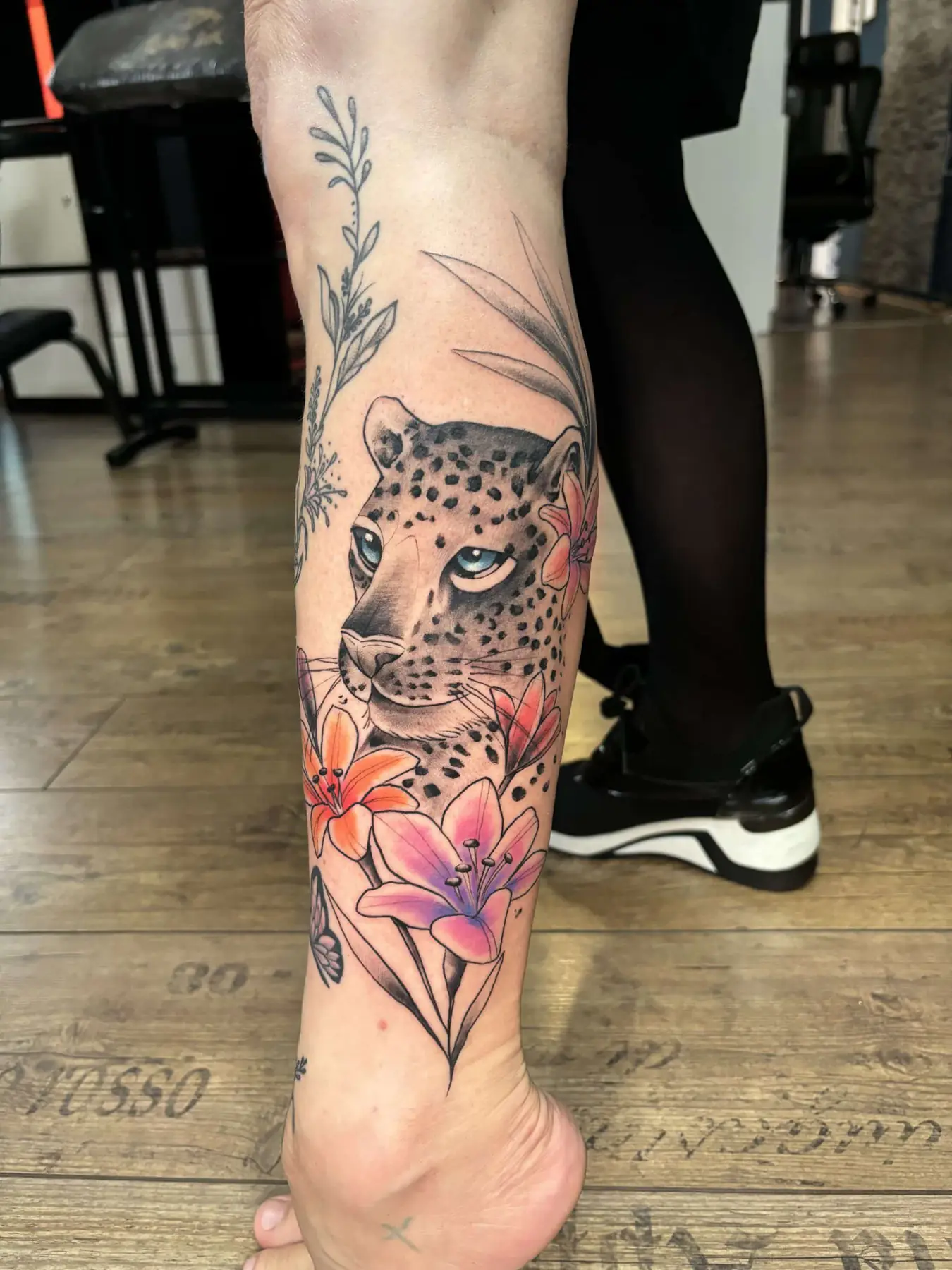Leopard among pink flowers. Tattoo at Ink21 in Vienna.