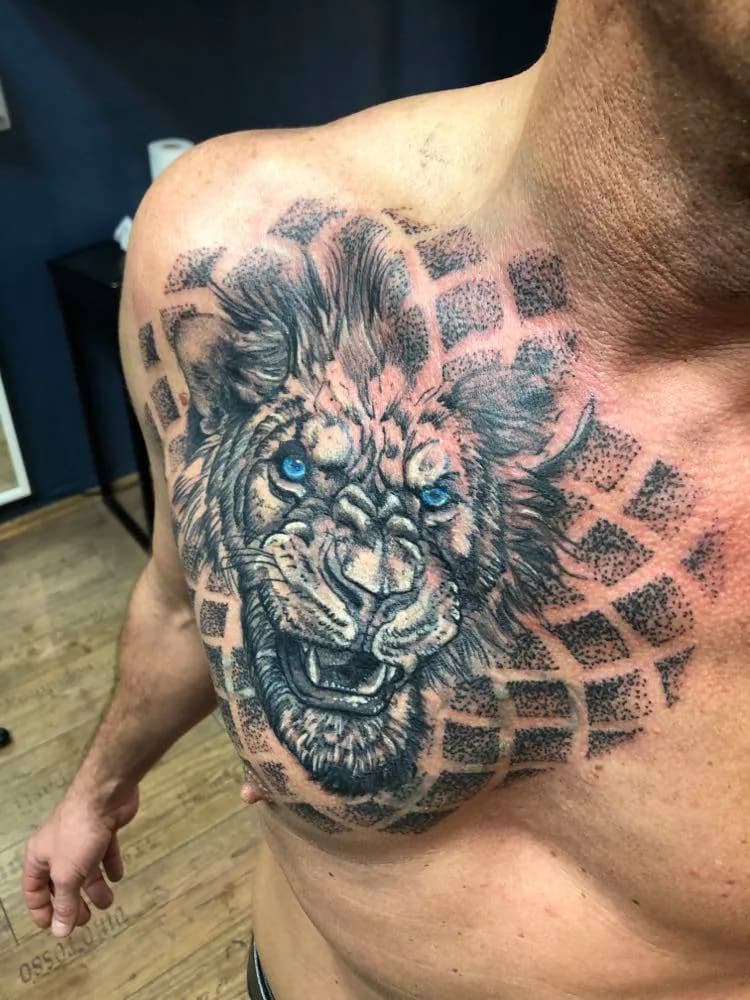 Blue-eyed lion on the chest. Tattoo at Ink21 in Vienna.