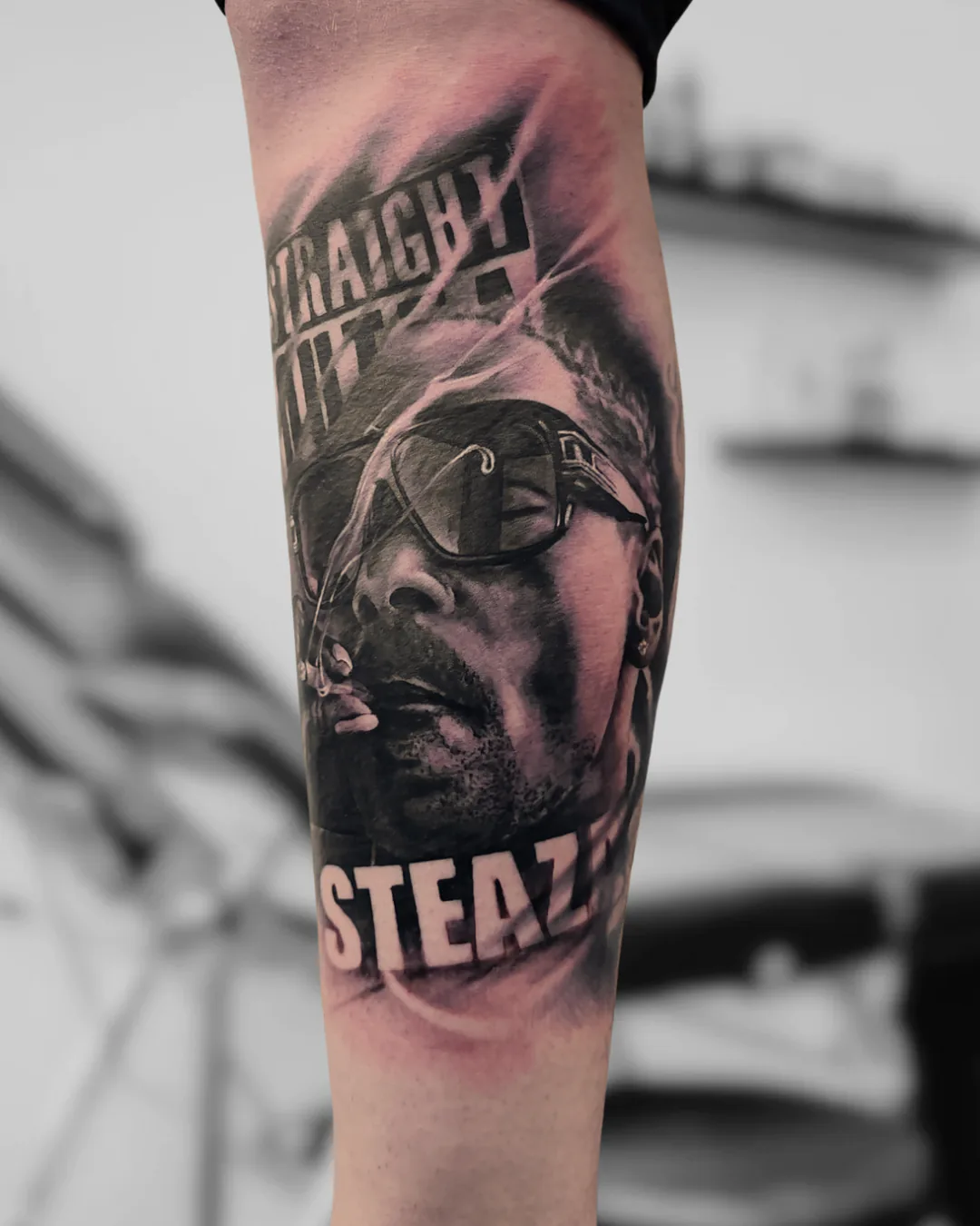 Man’s portrait with glasses and lettering. Tattoo at Ink21 in Vienna.