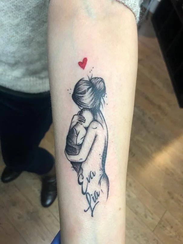 Mother and child with a red heart. Tattoo at Ink21 in Vienna.