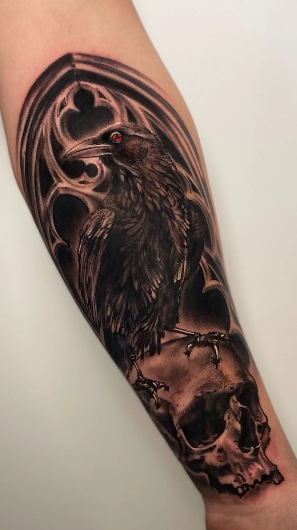 Raven perched on a skull. Tattoo at Ink21 in Vienna.