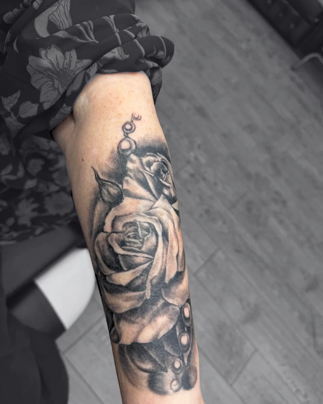 Rose beneath a woman’s portrait. Tattoo at Ink21 in Vienna.