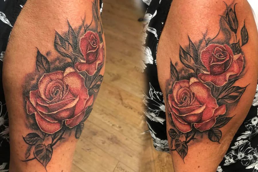 Red roses in two views of the leg. Tattoo at Ink21 in Vienna.