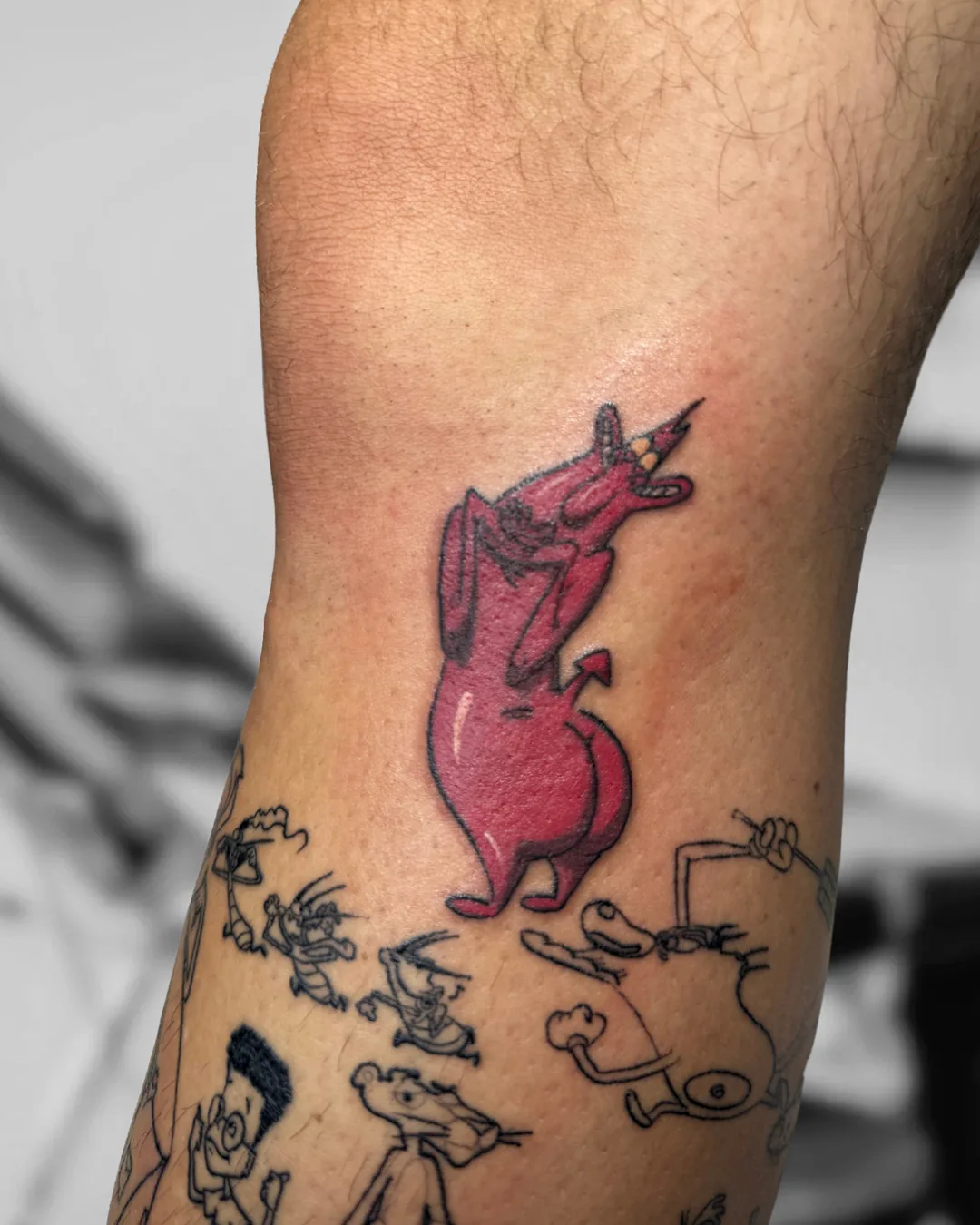 Red cartoon devil on the leg. Tattoo at Ink21 in Vienna.