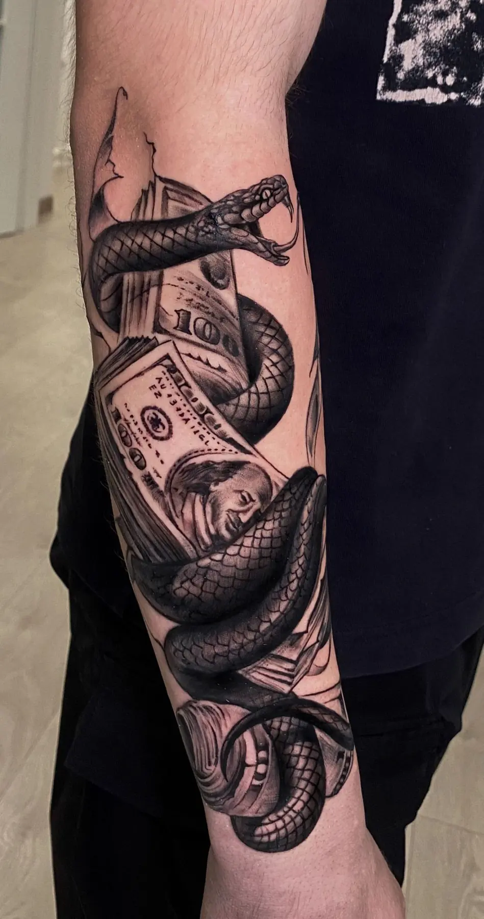 Snake among banknotes. Tattoo at Ink21 in Vienna.