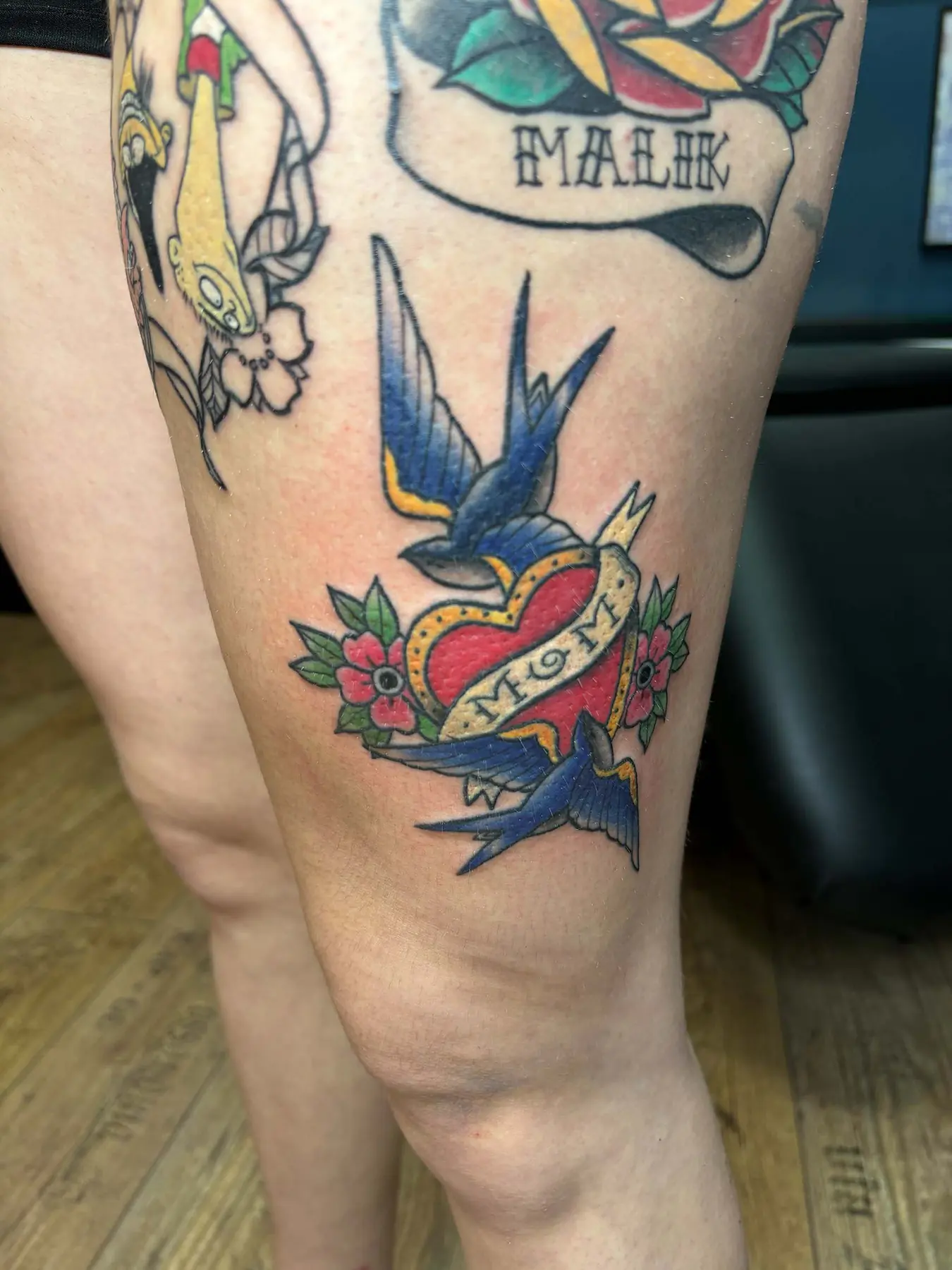 Swallows around a red heart. Tattoo at Ink21 in Vienna.
