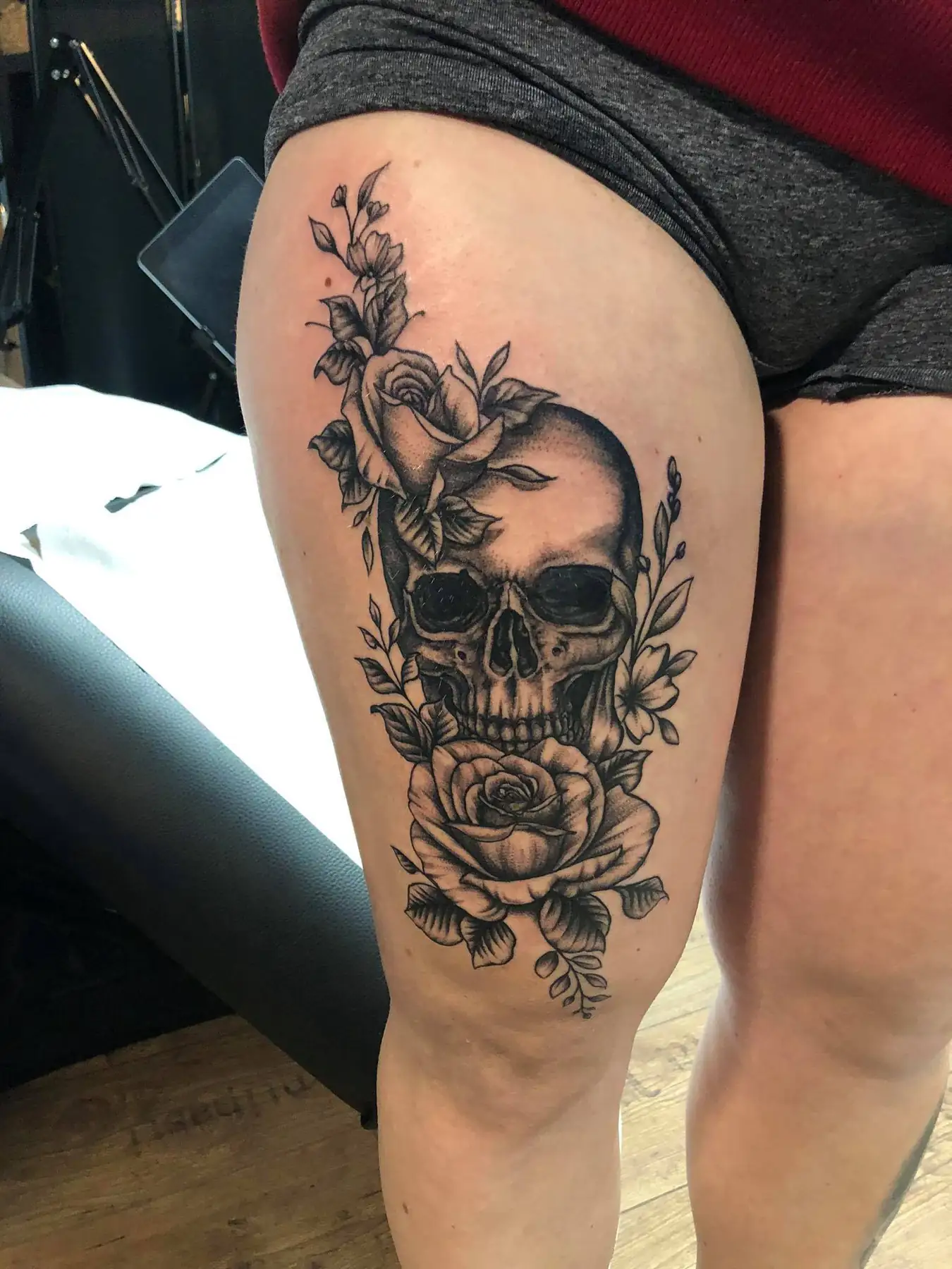 Skull between two roses. Tattoo at Ink21 in Vienna.
