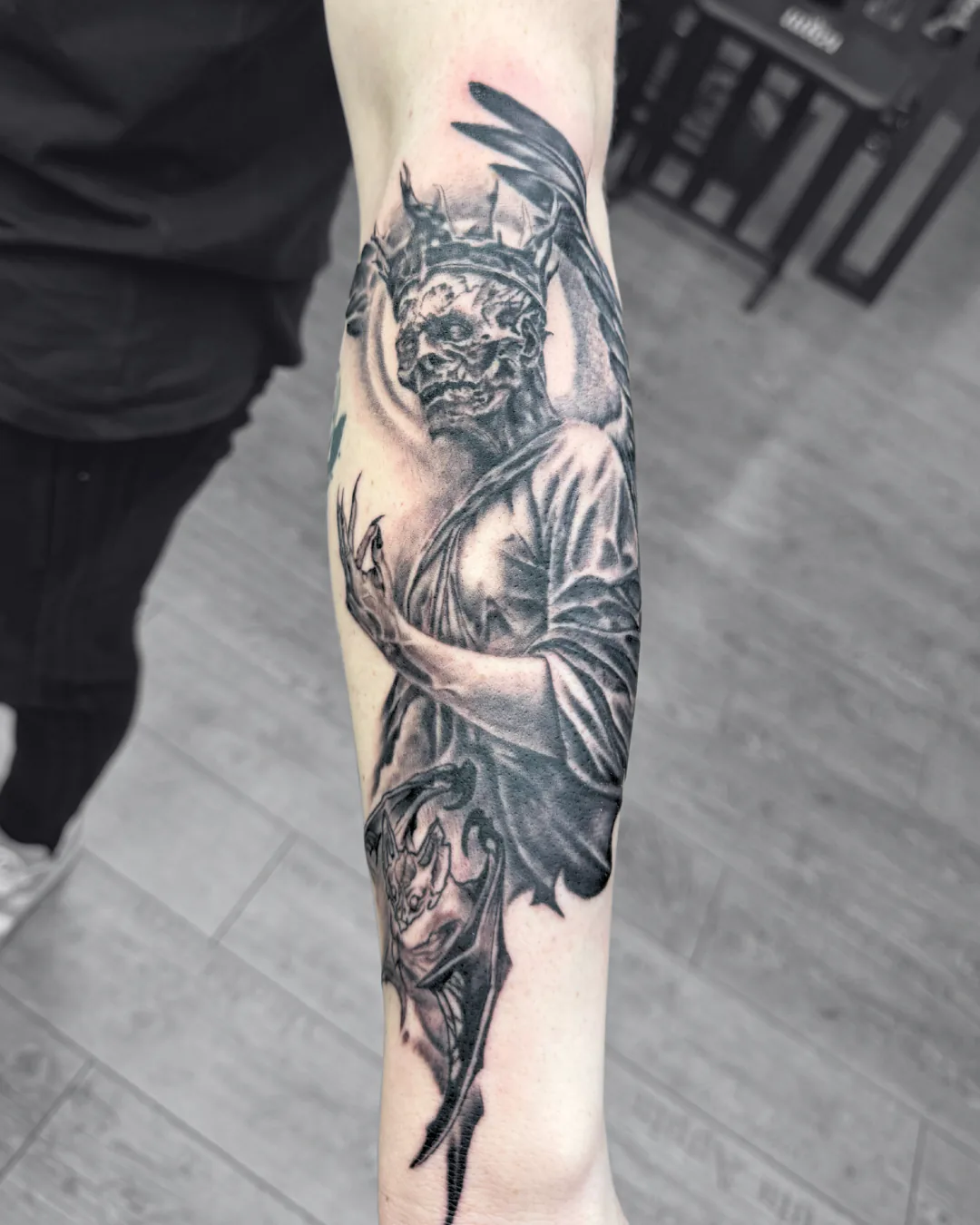 Hooded face with a skull half. Tattoo at Ink21 in Vienna.