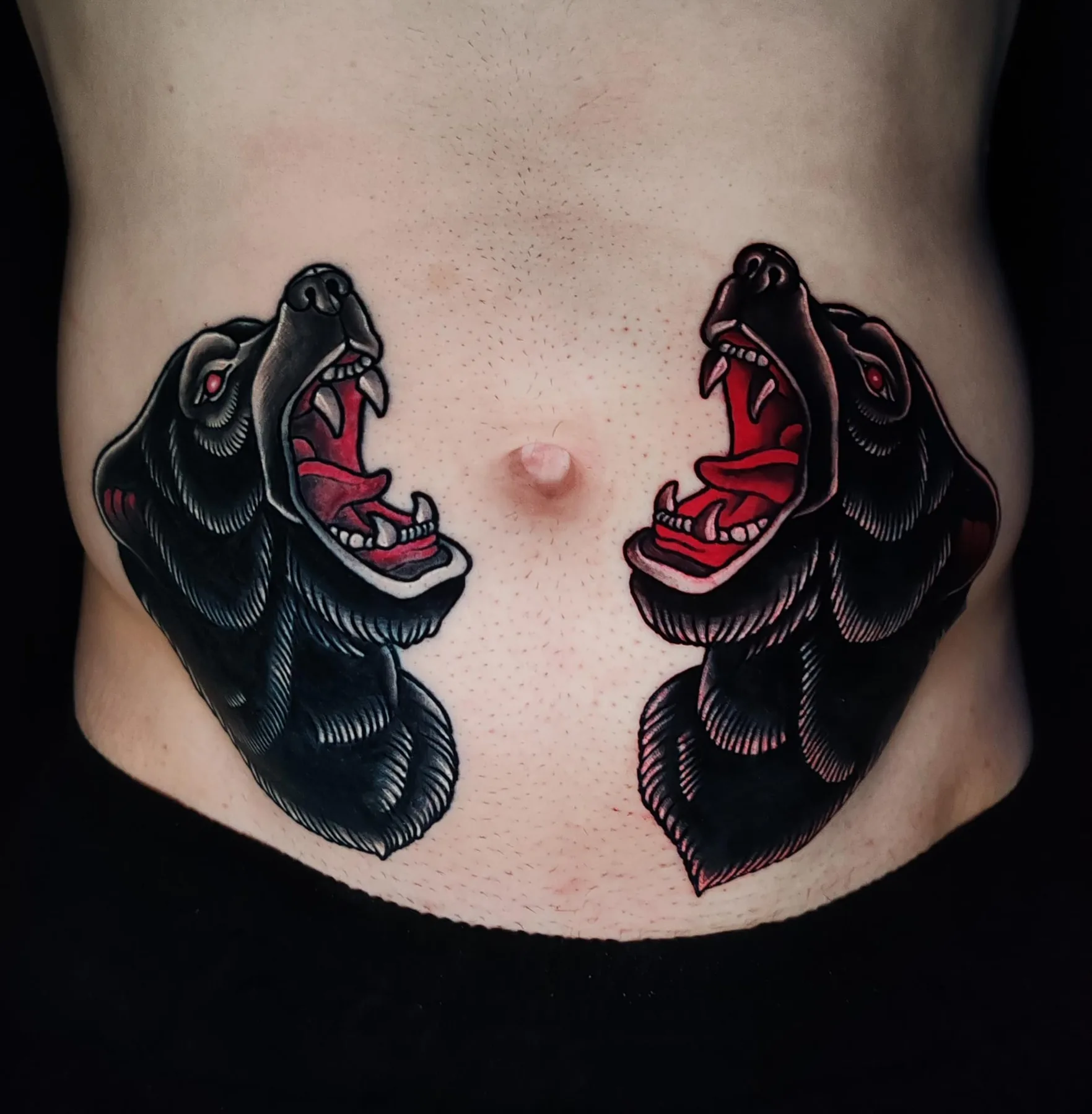 Two panther heads on the abdomen. Tattoo at Ink21 in Vienna.